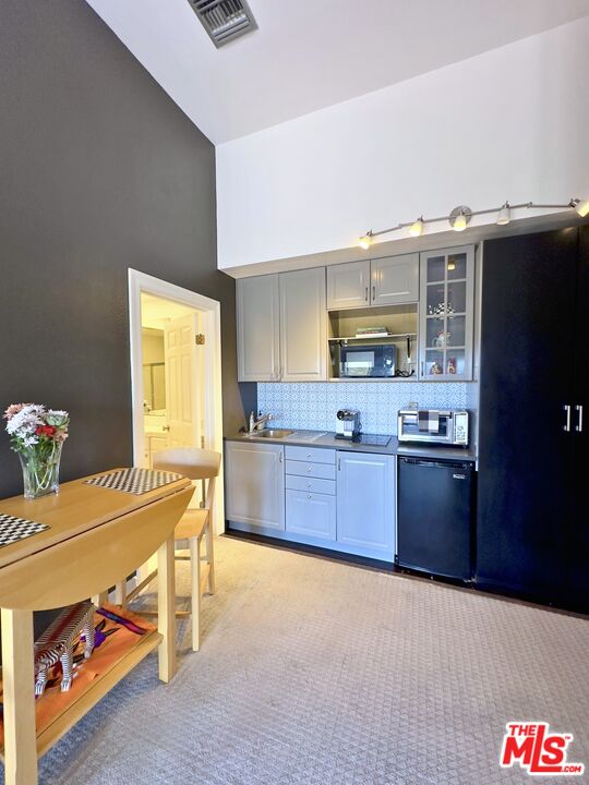 6140 Cavalleri Road, Unit GH Malibu, CA 90265 - Photo 14 of 24 a kitchen with stainless steel appliances wooden cabinets a stove and a refrigerator