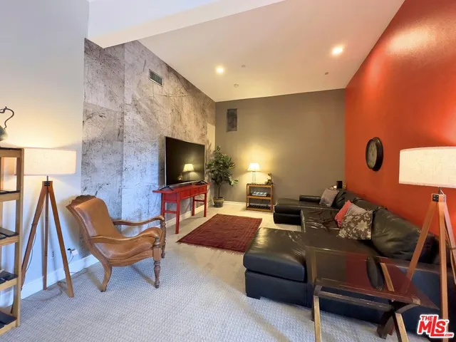 a living room with furniture a rug and a large window