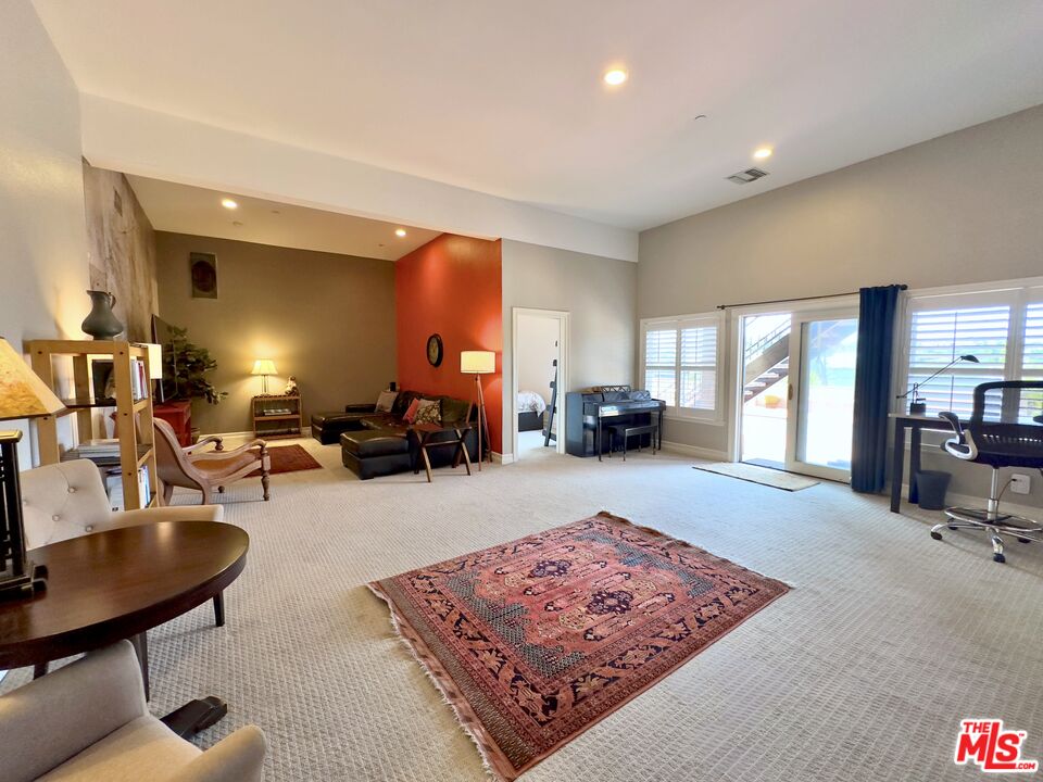 6140 Cavalleri Road, Unit GH Malibu, CA 90265 - Photo 5 of 24 a living room with furniture a rug and a large window