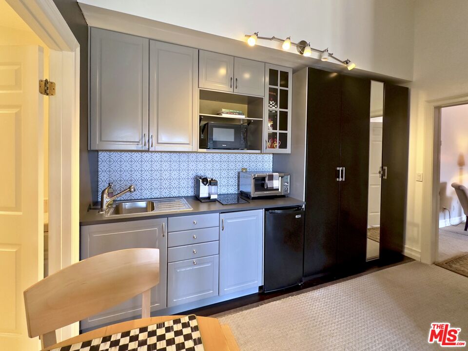 6140 Cavalleri Road, Unit GH Malibu, CA 90265 - Photo 10 of 24 a kitchen with stainless steel appliances granite countertop a refrigerator and a stove top oven