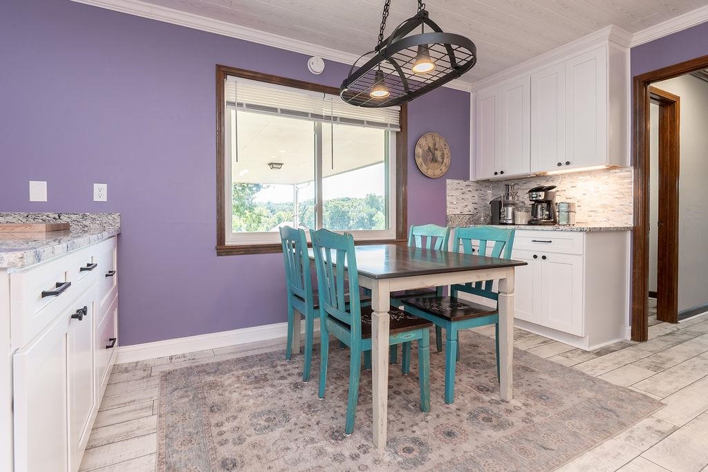 5870 Monk House Road Somerville, TN 38068 - Photo 12 of 40 a dining room with furniture a rug and a chandelier