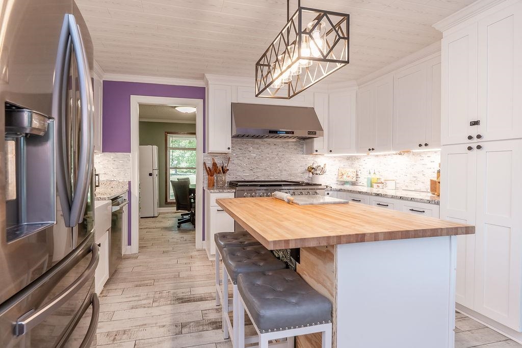 5870 Monk House Road Somerville, TN 38068 - Photo 13 of 40 a kitchen with kitchen island a sink stove and refrigerator