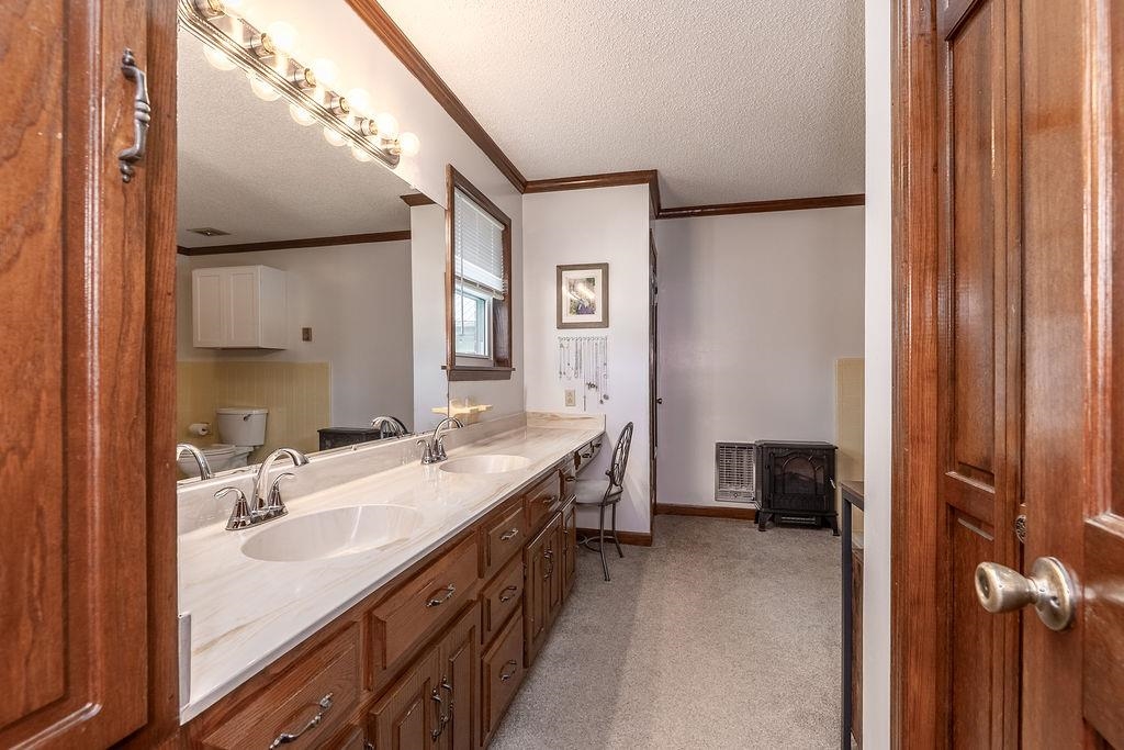 5870 Monk House Road Somerville, TN 38068 - Photo 21 of 40 a en suite bathroom with a double vanity sink a mirror and a shower