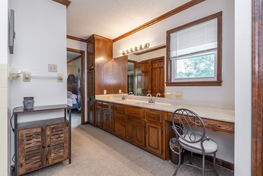 5870 Monk House Road Somerville, TN 38068 - Photo 23 of 40 a spacious bathroom with a granite countertop sink and a mirror
