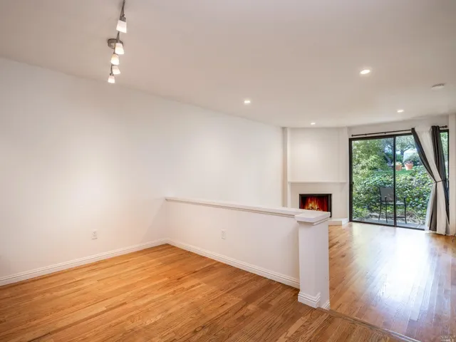 a view of a kitchen with a sink and wooden floor