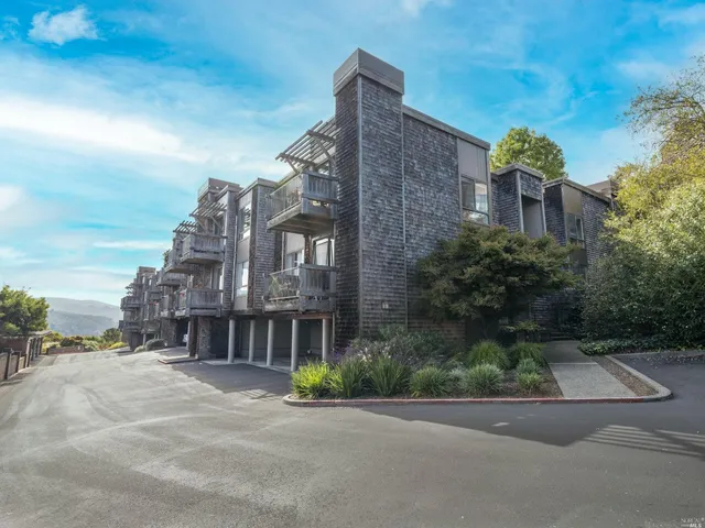 a front view of a building with a garden