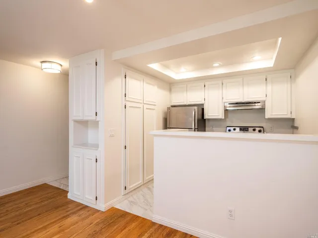 a kitchen with stainless steel appliances a refrigerator and a stove top oven