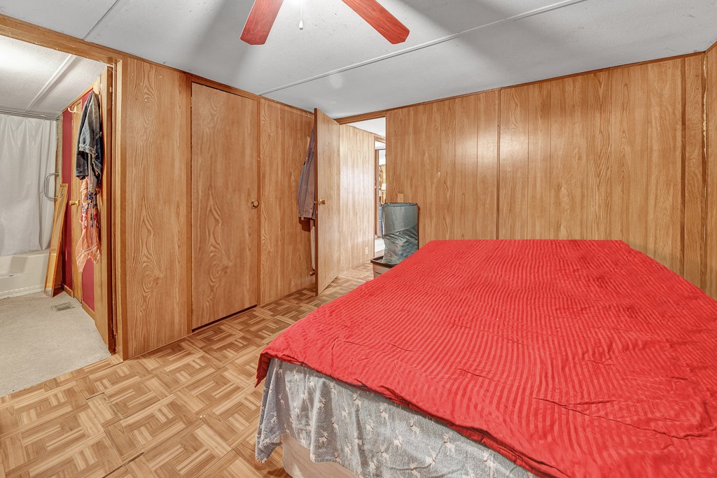 96697 Blackrock Road Yulee, FL 32097 - Photo 12 of 17 a bed room with a bed and a curtain