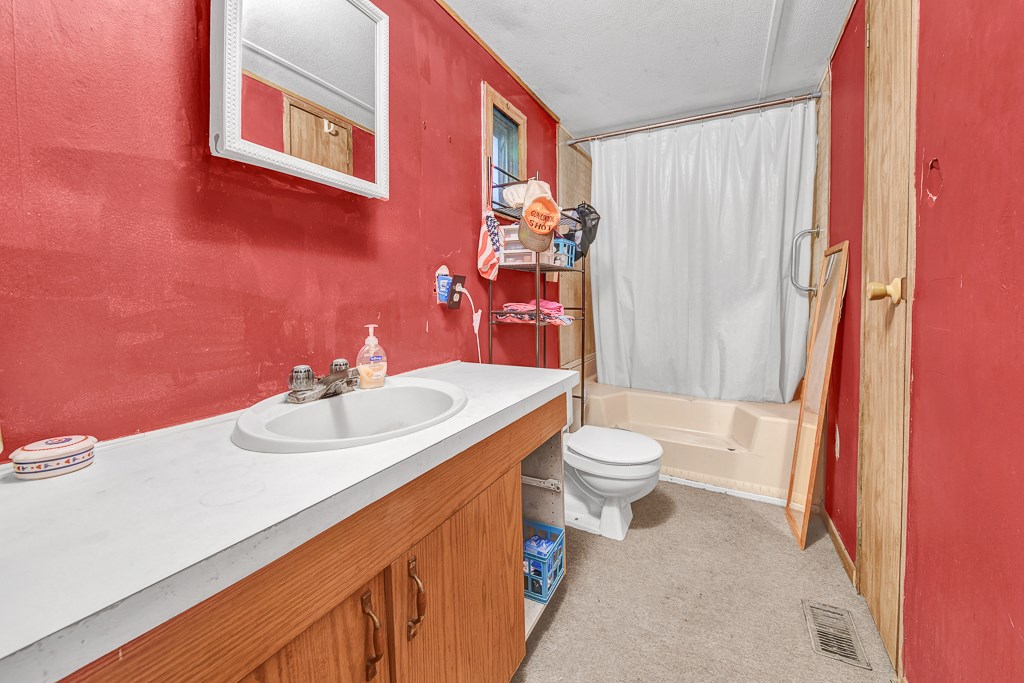 96697 Blackrock Road Yulee, FL 32097 - Photo 13 of 17 a bathroom with a sink a toilet and shower curtain