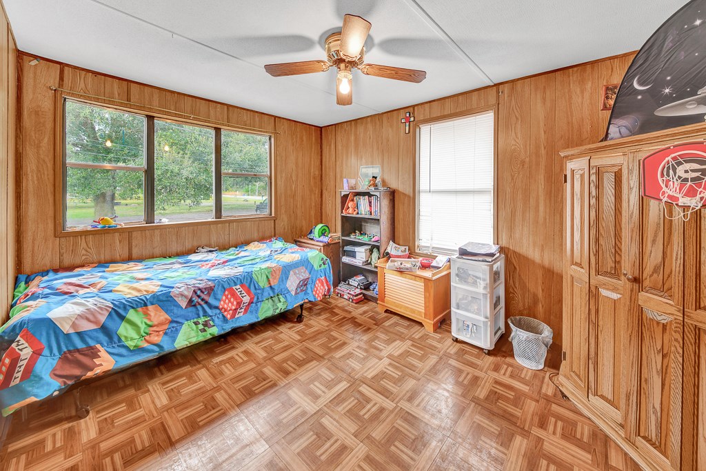 96697 Blackrock Road Yulee, FL 32097 - Photo 9 of 17 a bed room with a bed and a chandelier