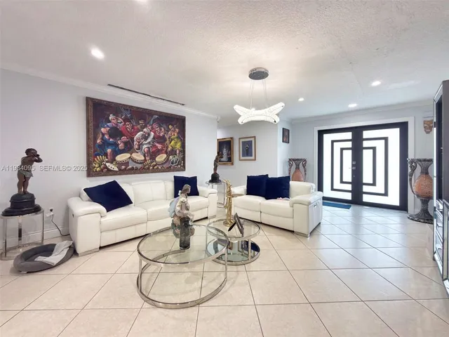 a living room with furniture a table and a painting