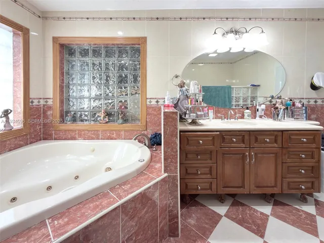 a bathroom with a bathtub sink and mirror