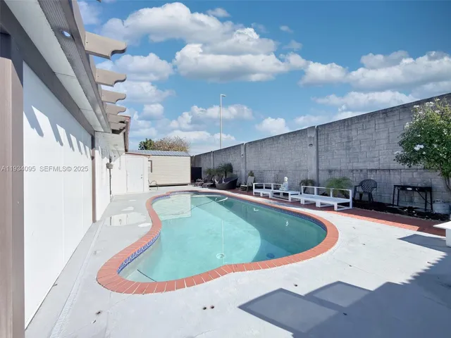 a view of a swimming pool with a yard