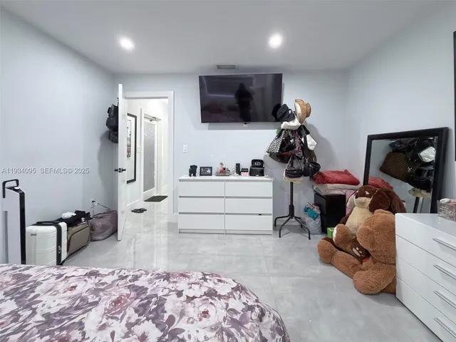 a bed room with a bed and a television