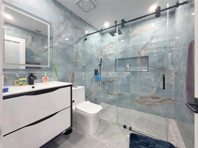 a bathroom with a sink toilet and shower