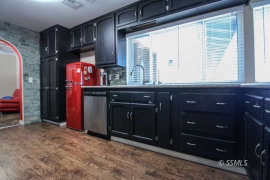 900 North Sierra View Street Ridgecrest, CA 93555 - Photo 10 of 42 a kitchen with a refrigerator and window