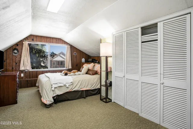 a bed room with a bed and a window