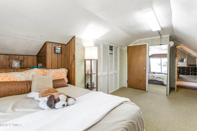 a bedroom with a large bed and a couch