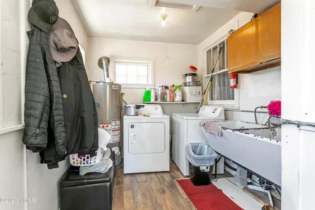 a room with sink dryer and washer