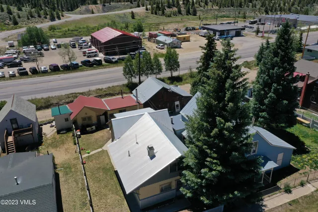 an aerial view of a house with garden space and lake view