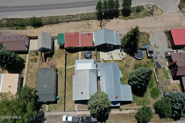 an aerial view of residential houses with outdoor space