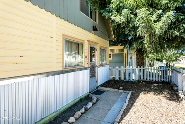 a view of a house with a wooden fence