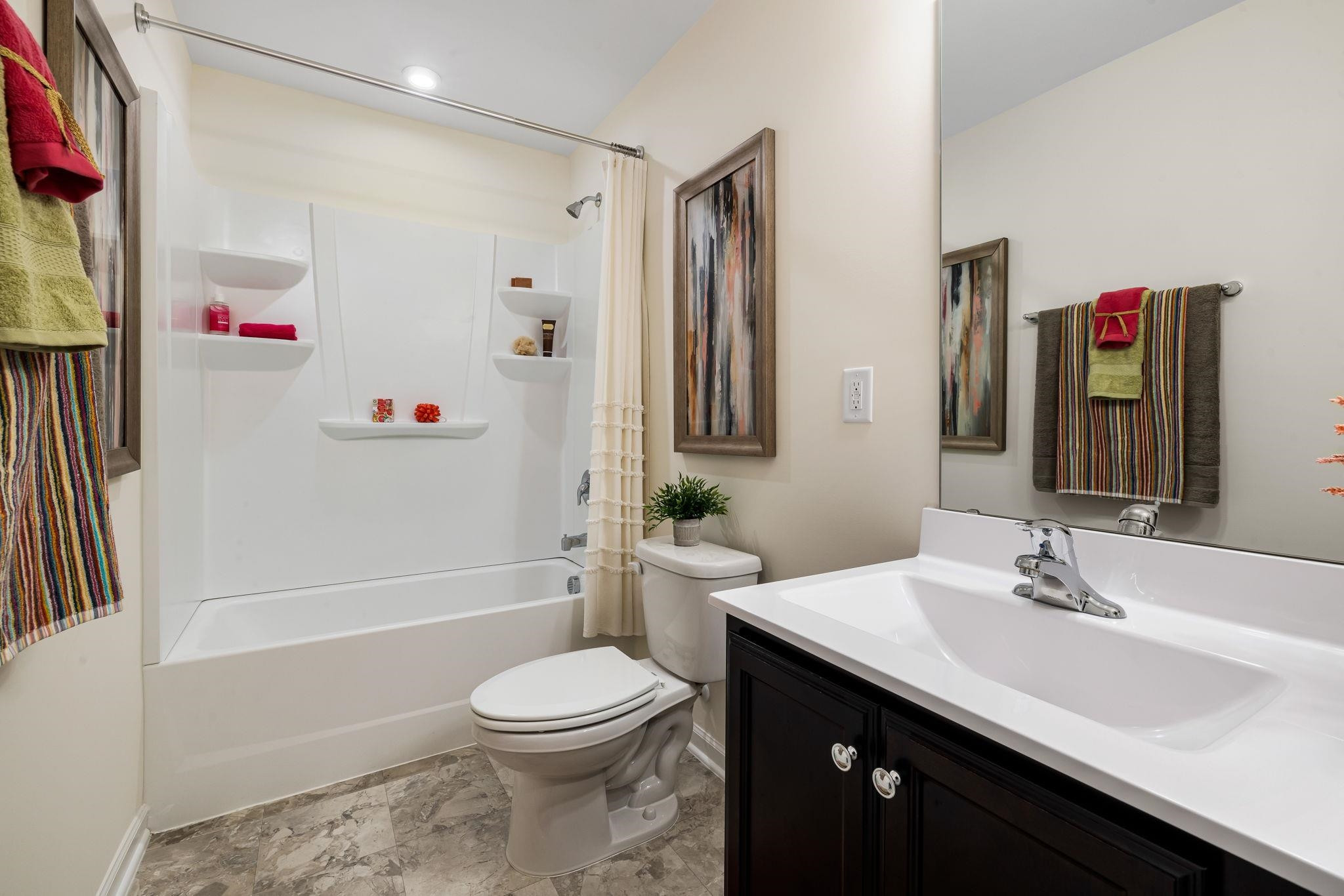 6512 Winter Spring Drive Wake Forest, NC 27587 - Photo 27 of 34 a bathroom with a sink a toilet and a bathtub