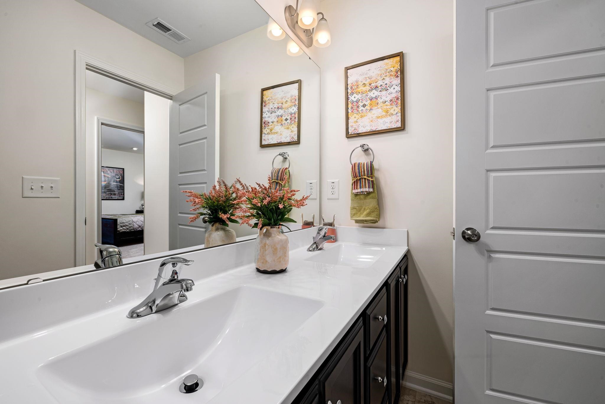 6512 Winter Spring Drive Wake Forest, NC 27587 - Photo 28 of 34 a bathroom with a sink and a mirror
