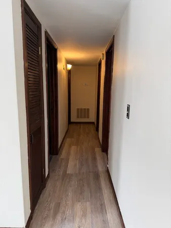 a view of hallway with wooden floor