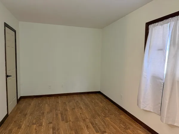 a view of wooden floor and brick walls