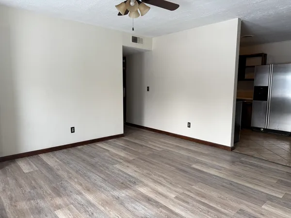 a view of a room with wooden floor