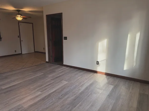a view of empty room with wooden floor