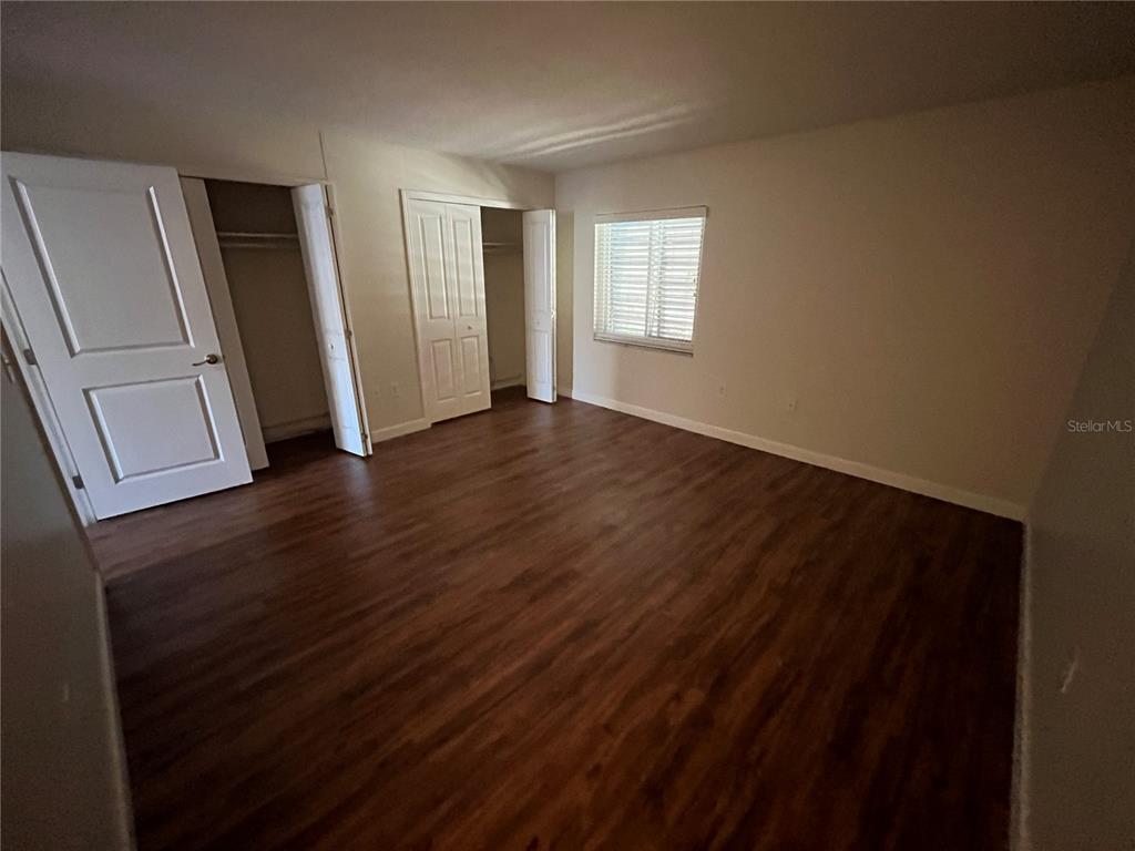210 Magnolia Road, Unit 104 Maitland, FL 32751 - Photo 11 of 16 a view of an empty room with wooden floor and a window