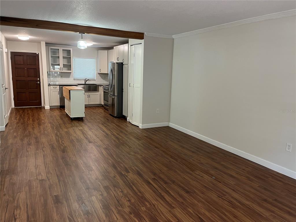 210 Magnolia Road, Unit 104 Maitland, FL 32751 - Photo 6 of 16 a view of a kitchen with wooden floor and electronic appliances