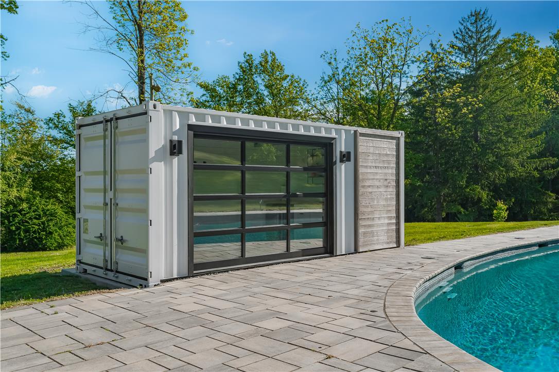 1506 Pleasant View Road Coopersburg, PA 18036 - Photo 87 of 97 An innovative poolside structure with a large glass garage door offers flexible space for recreation.