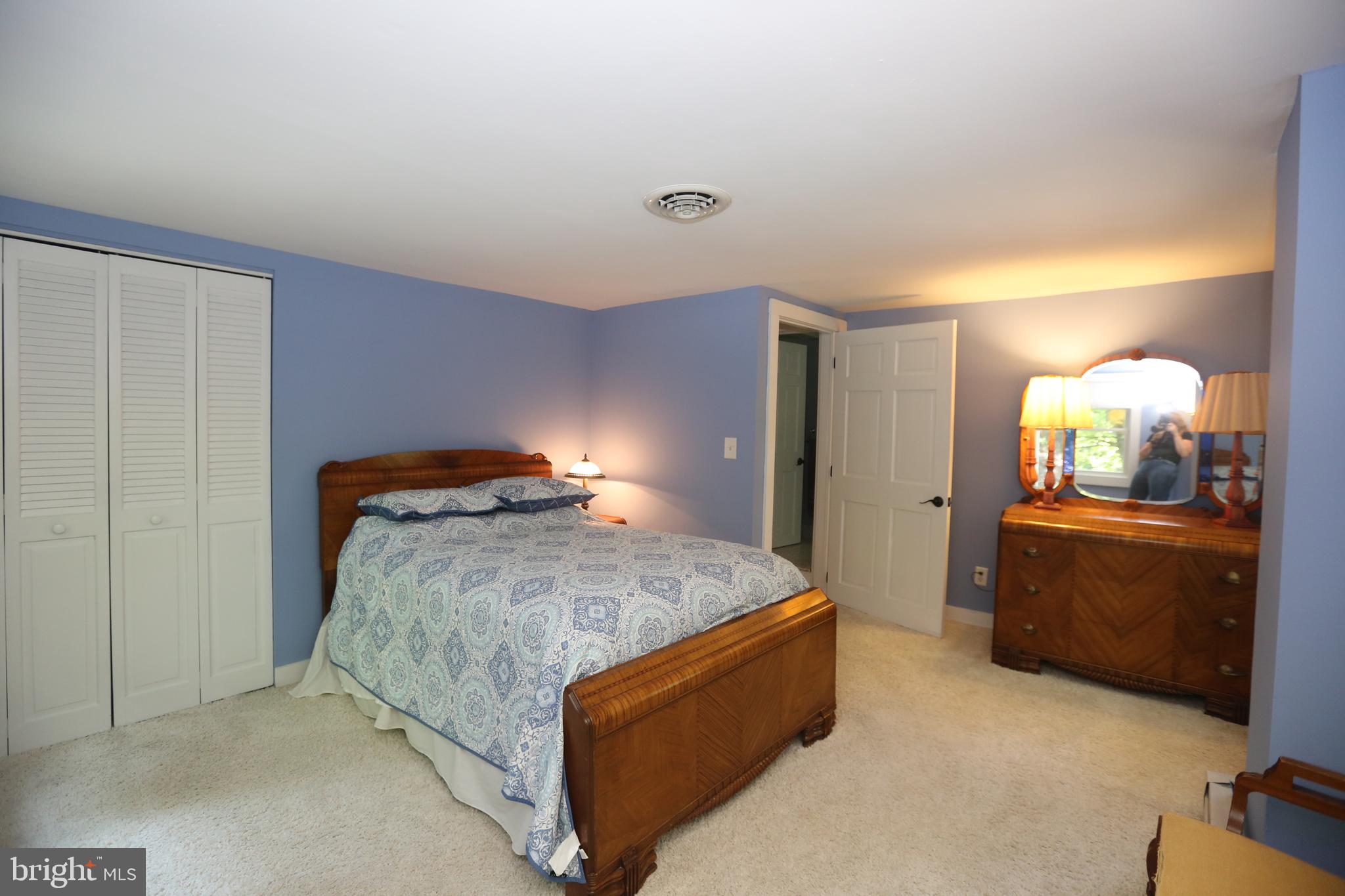 136 Lambs Road Sewell, NJ 08080 - Photo 23 of 65 a bedroom with a bed and a mirror on dresser