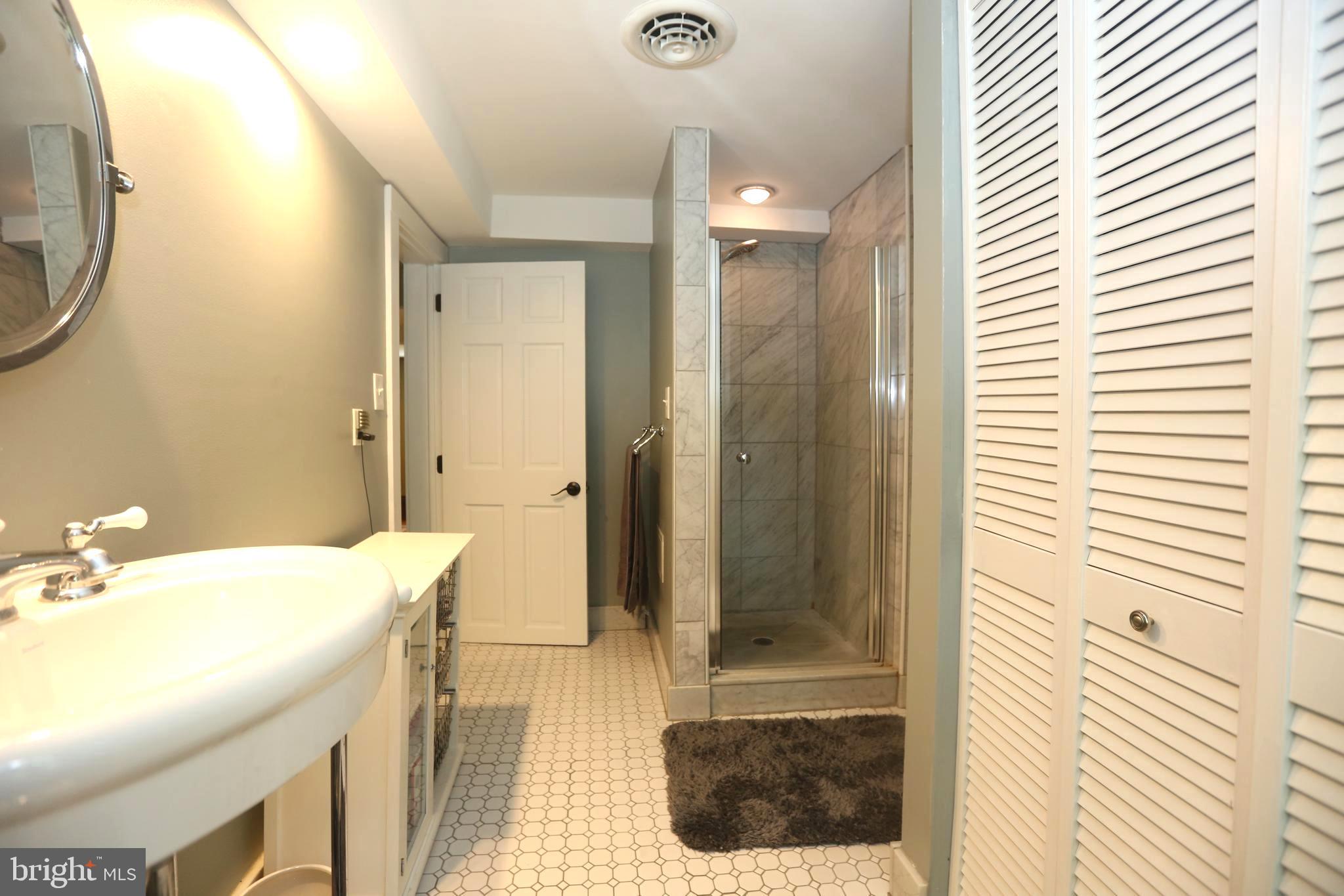 136 Lambs Road Sewell, NJ 08080 - Photo 28 of 65 a bathroom with a sink a toilet and shower