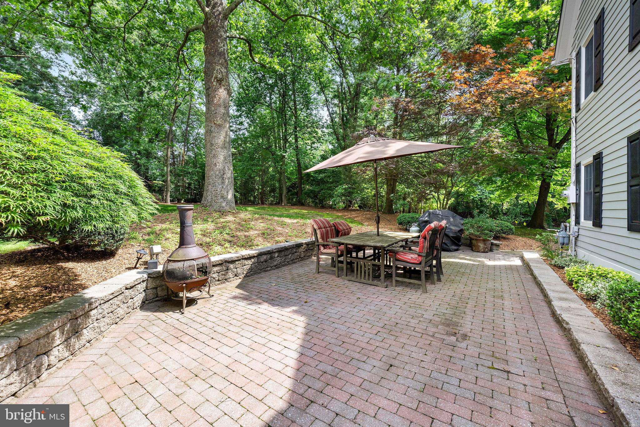 136 Lambs Road Sewell, NJ 08080 - Photo 48 of 65 a view of backyard with table and chairs under an umbrella