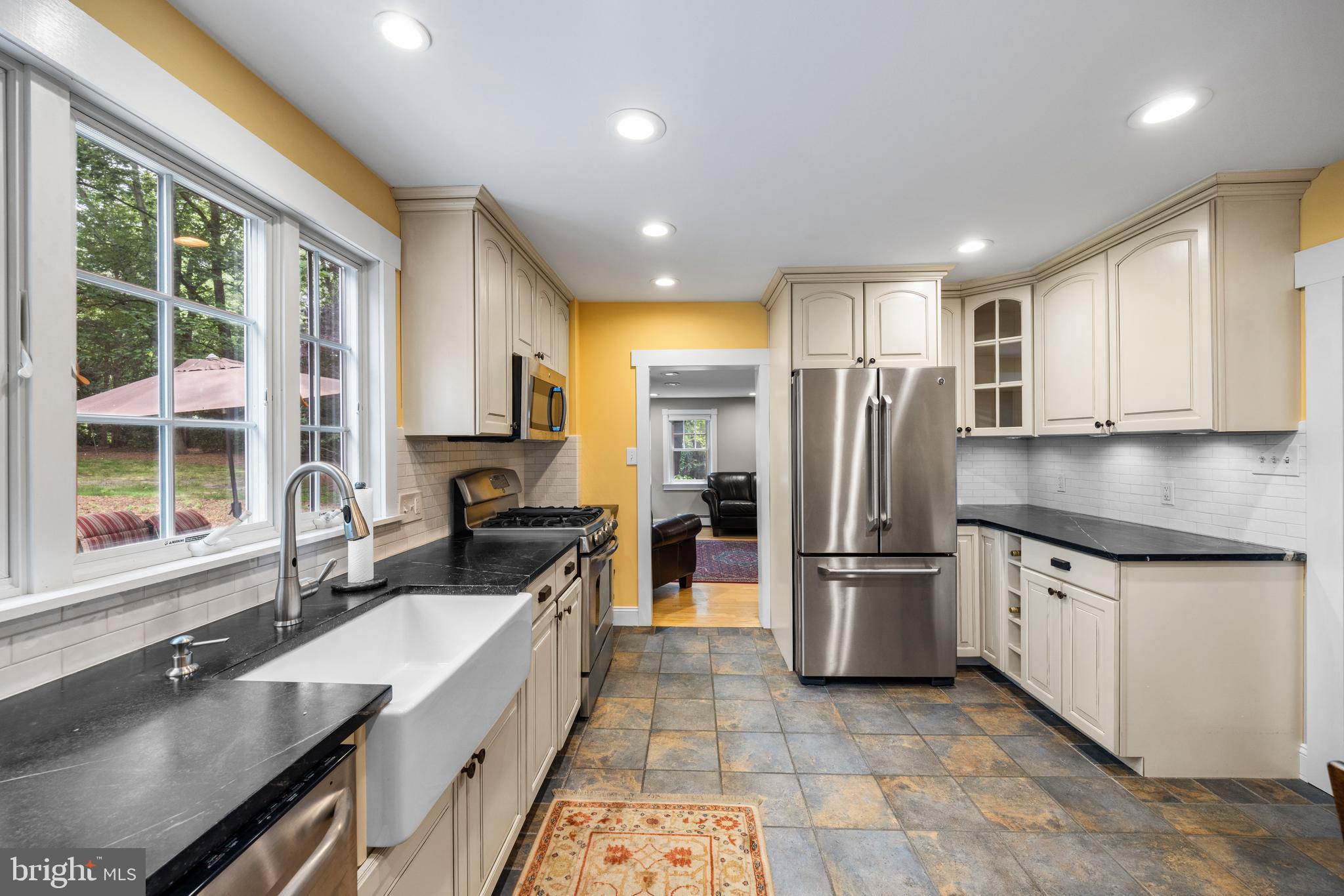 136 Lambs Road Sewell, NJ 08080 - Photo 10 of 65 a large kitchen with granite countertop a large counter top stainless steel appliances a sink cabinets and a window