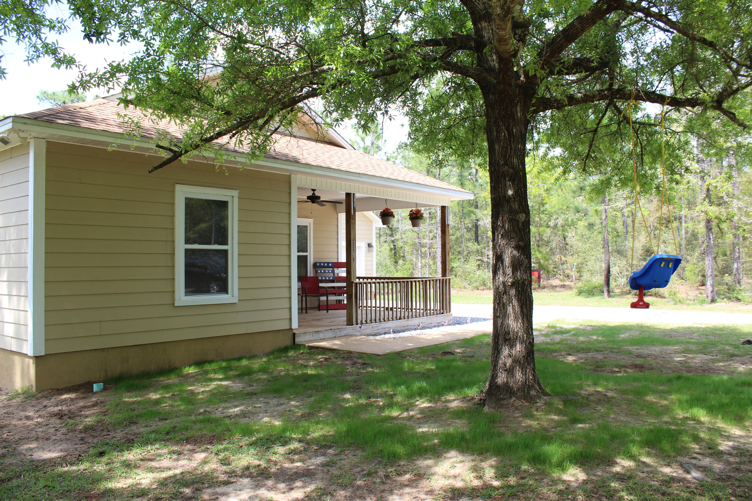 1563 Hinote Road DeFuniak Springs, FL 32433 - Photo 6 of 36 a house with a tree in front of it