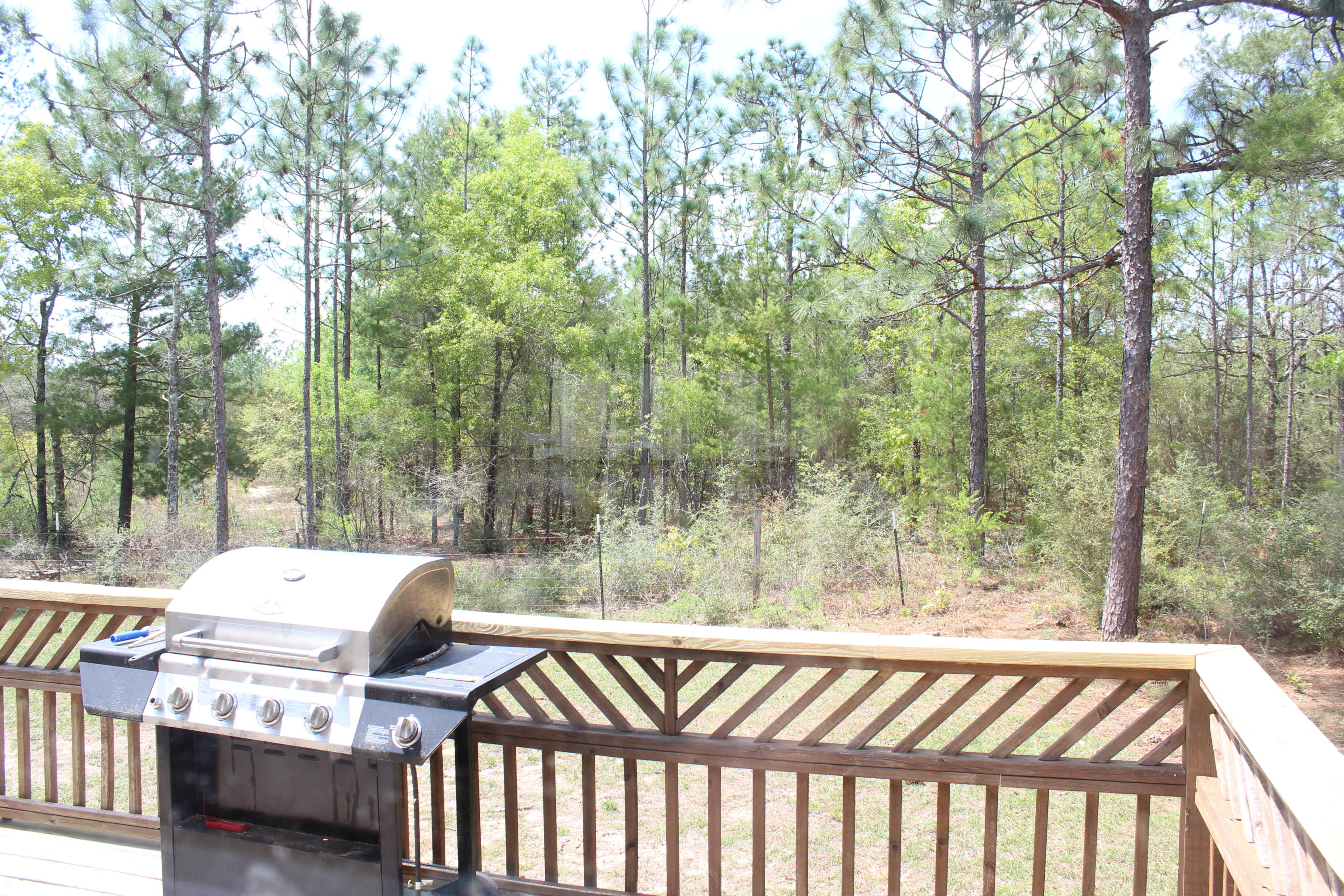 1563 Hinote Road DeFuniak Springs, FL 32433 - Photo 7 of 36 a view of balcony with wooden floor and outdoor seating