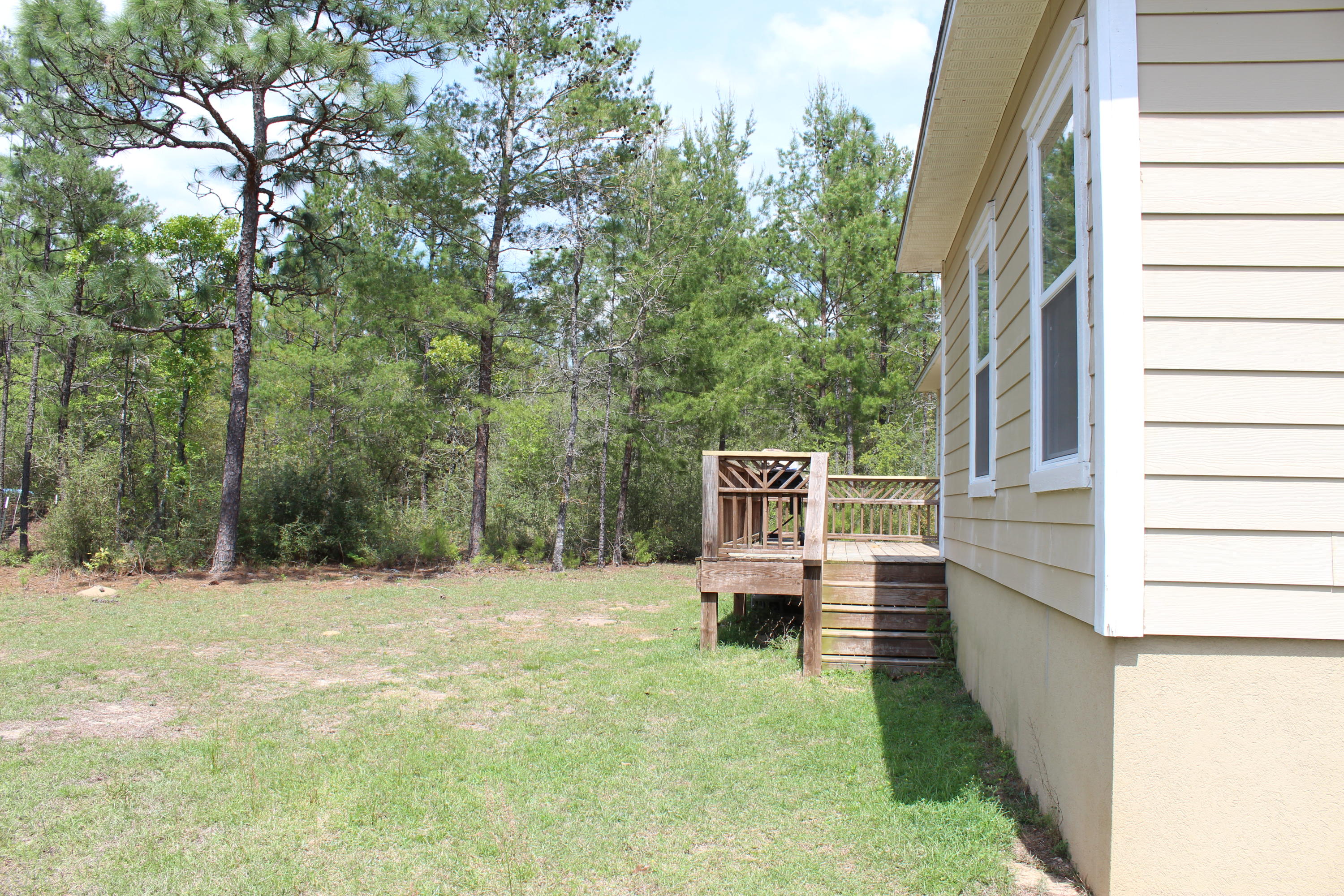 1563 Hinote Road DeFuniak Springs, FL 32433 - Photo 9 of 36 a view of house with backyard space and wooden fence