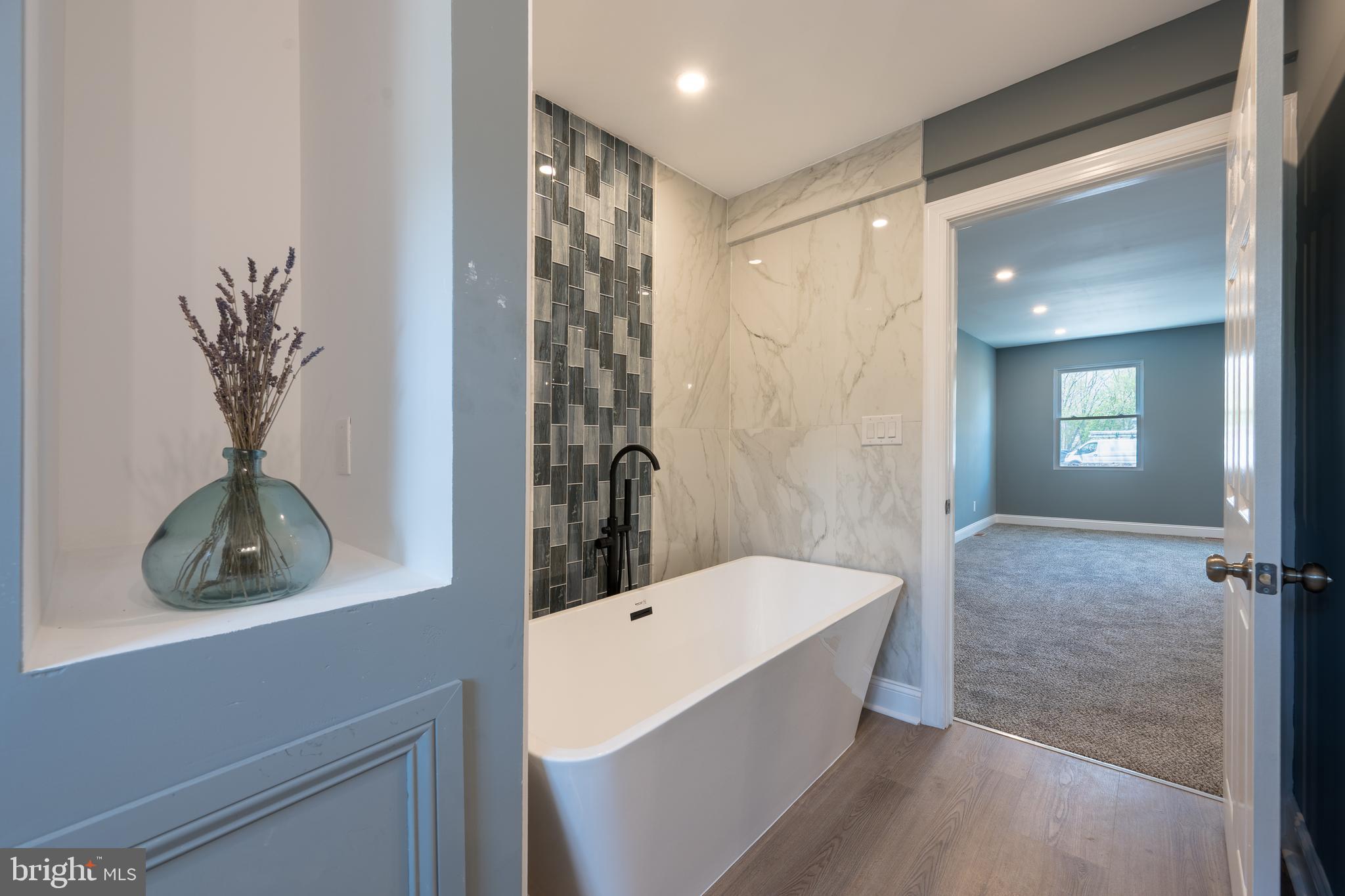 3 Slalom Court Pine Hill, NJ 08021 - Photo 23 of 47 a bathroom with a bathtub sink and mirror