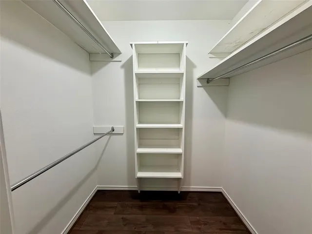 a view of walk in closet with empty racks