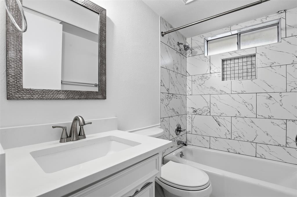 7351 Wellcrest Drive Dallas, TX 75230 - Photo 16 of 20 a bathroom with a sink toilet and shower