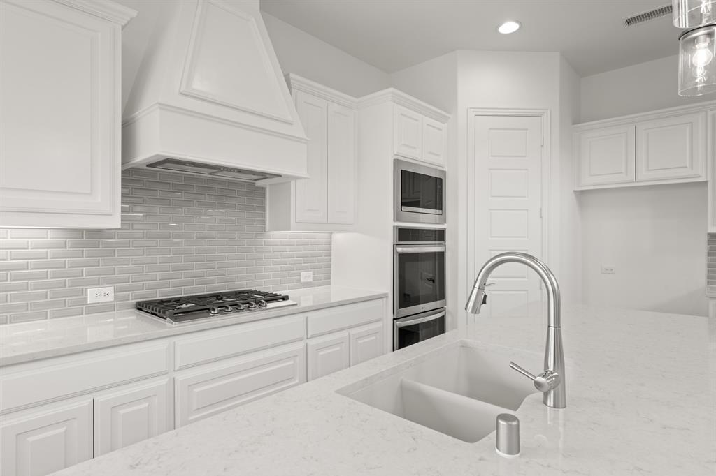 1536 Euclid Alley Corinth, TX 76208 - Photo 17 of 35 a kitchen with granite countertop a stove and a sink