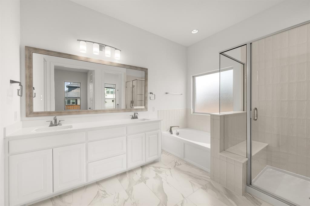 1536 Euclid Alley Corinth, TX 76208 - Photo 21 of 35 a spacious bathroom with a double vanity sink a mirror and a bathtub