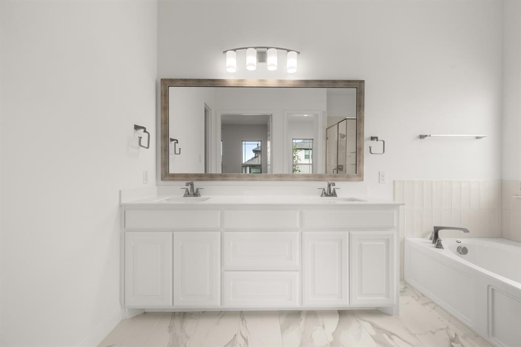 1536 Euclid Alley Corinth, TX 76208 - Photo 22 of 35 a bathroom with a double vanity sink mirror and bathtub