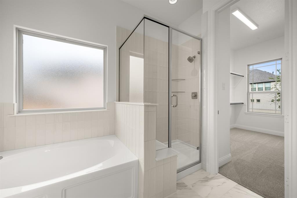 1536 Euclid Alley Corinth, TX 76208 - Photo 23 of 35 a bathroom with a bathtub and a shower