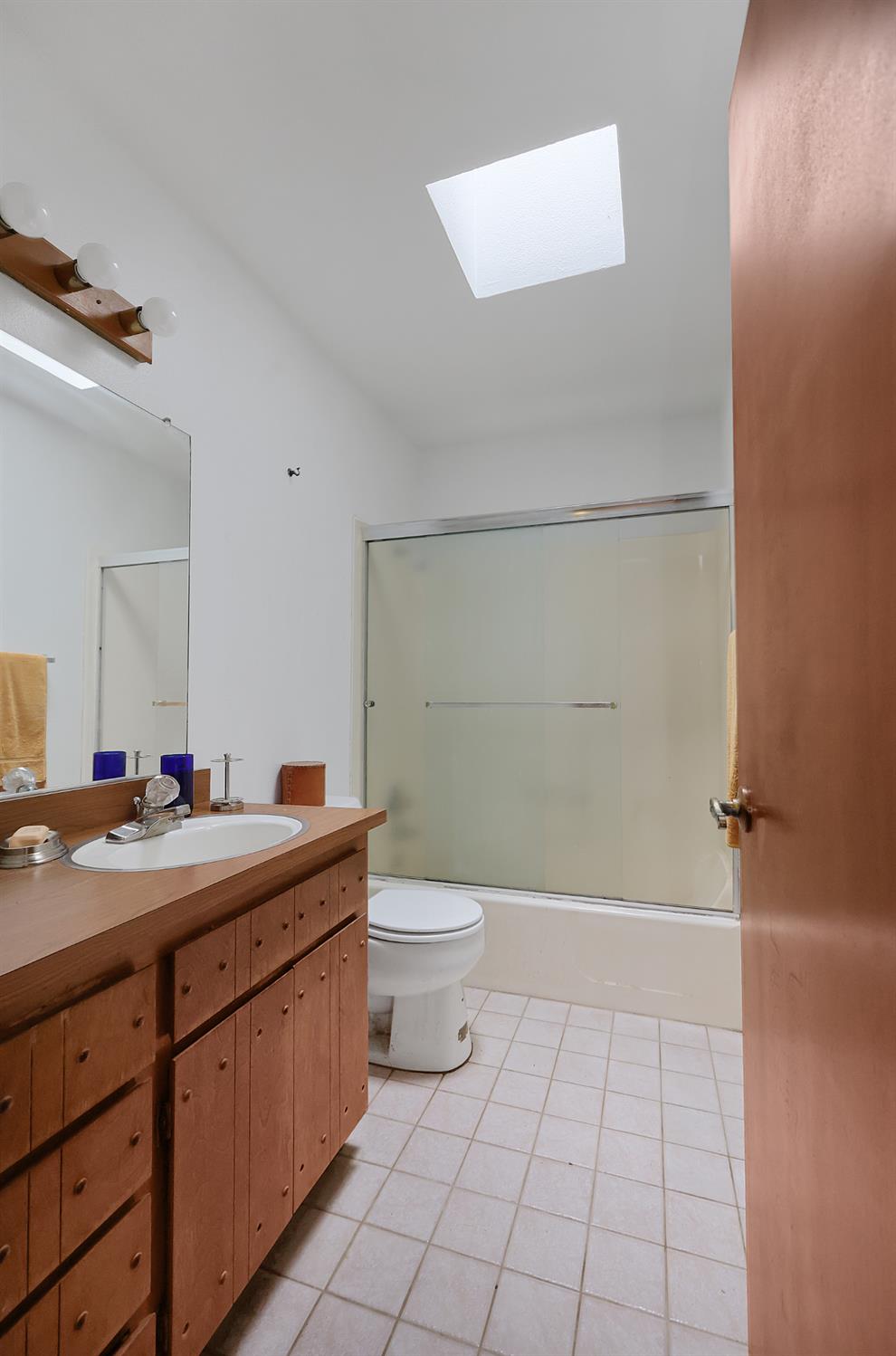 19688 Murphy Road Pine Grove, CA 95665 - Photo 6 of 8 a bathroom with a granite countertop sink a toilet and a mirror